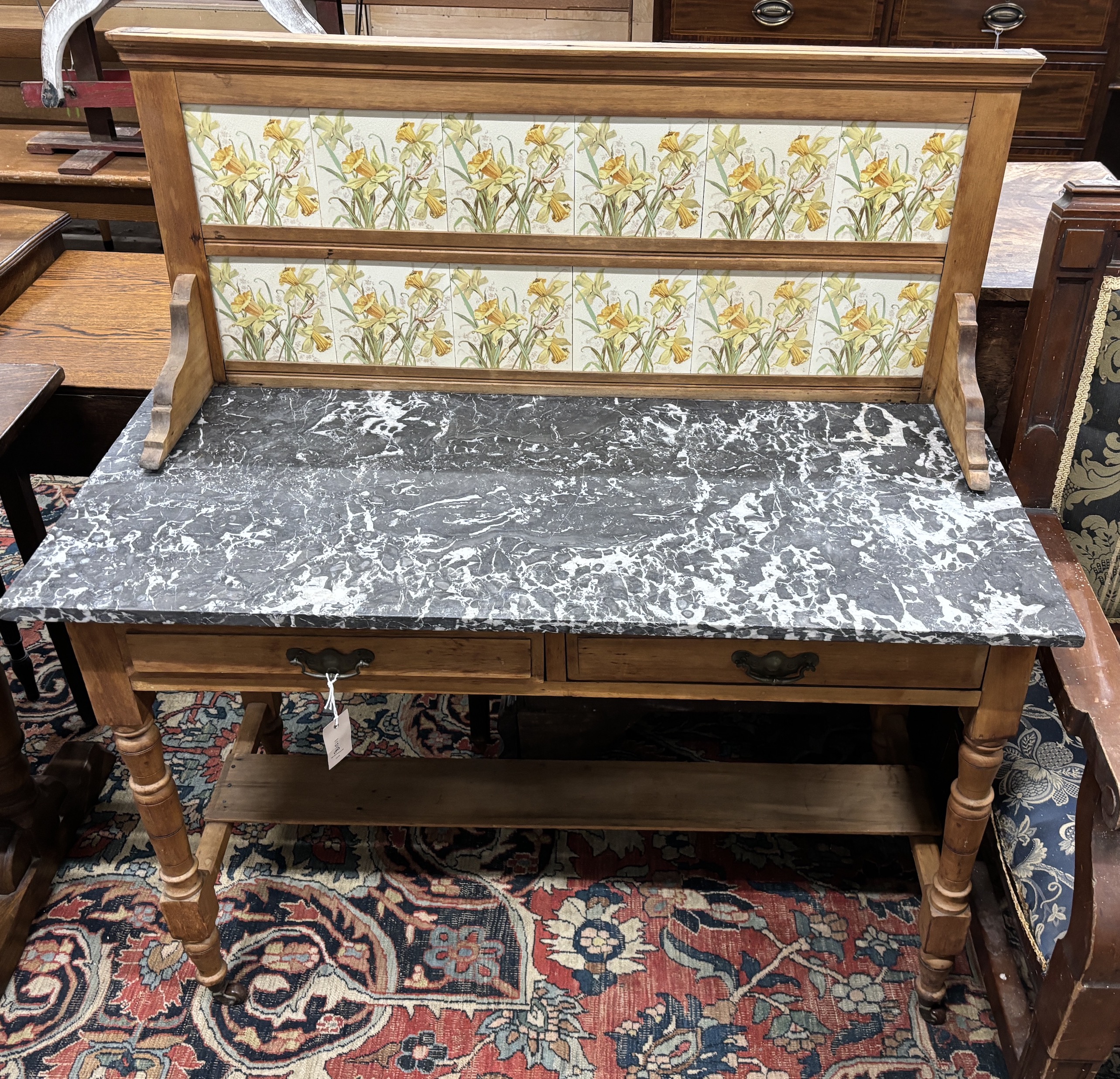 A late Victorian pine marble topped tiled back washstand, width 107cm, depth 51cm, height 116cm